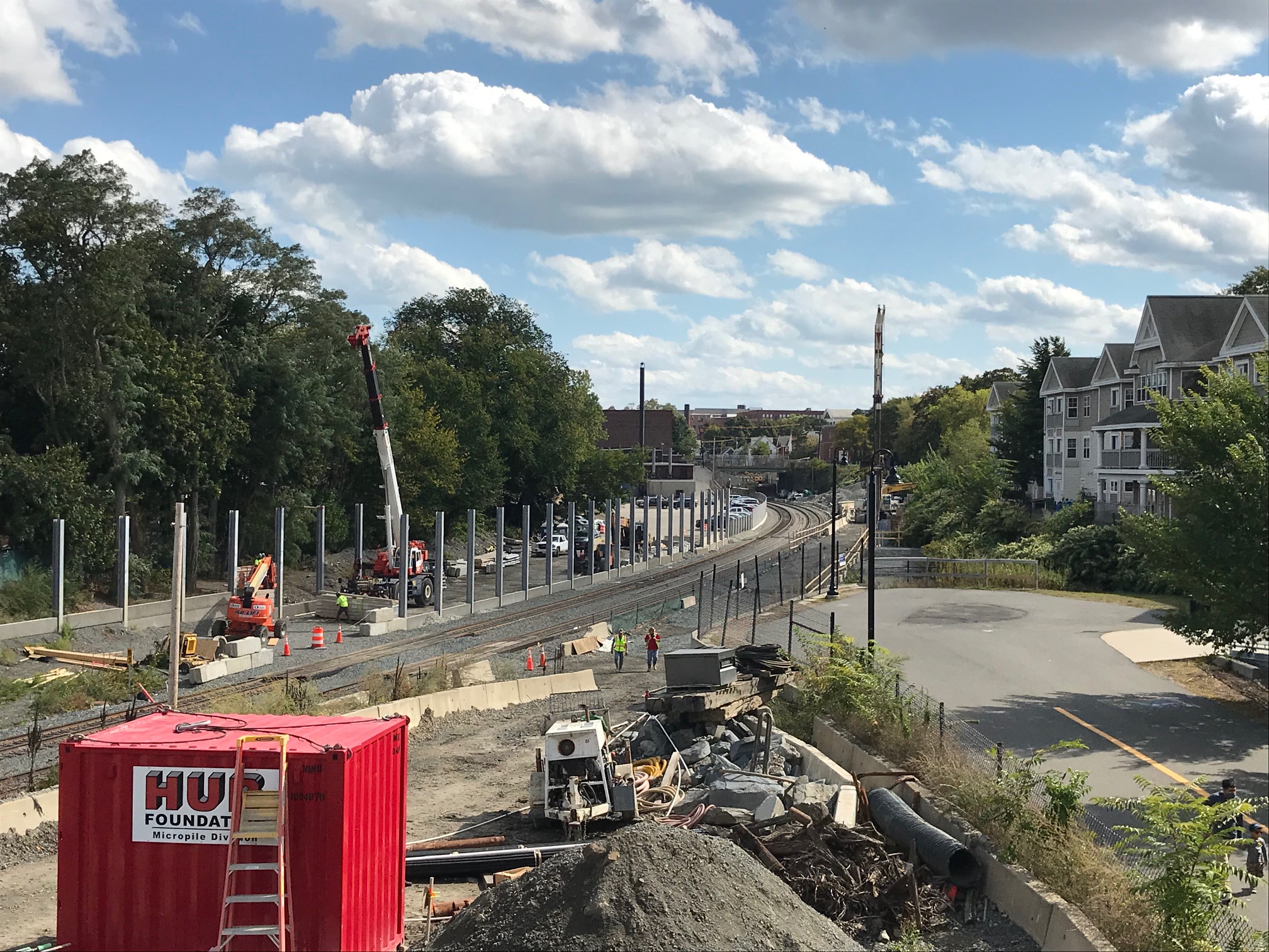A view east from the Lowell Street overpass next to the future Magoun Square station entrance. From here, the existing Community Path (at lower right) will be extended eastward along the future Green Line tracks.