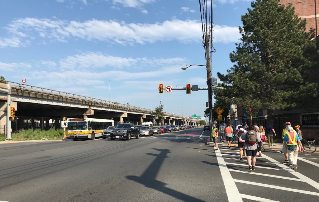 Mystic Ave. in Somerville at the intersection with Temple Street, with the Interstate 93 viaduct at left.