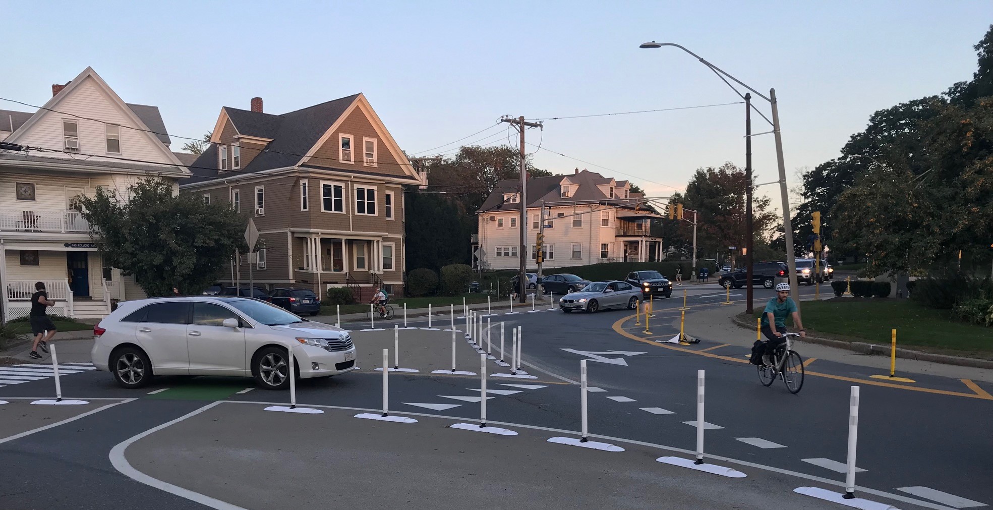 People on bikes navigate their way through the newly-reconfigured Powder House Circle in Somerville.