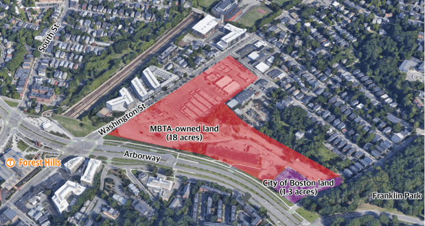 An aerial view of the neighborhood east of the Forest Hills subway station in Jamaica Plain highlighting the MBTA-owned land along the Arborway and Washington Street where the T plans to build a new bus garage. The site is highlighted in red and is shaped like a backwards seven in the middle of the image. 