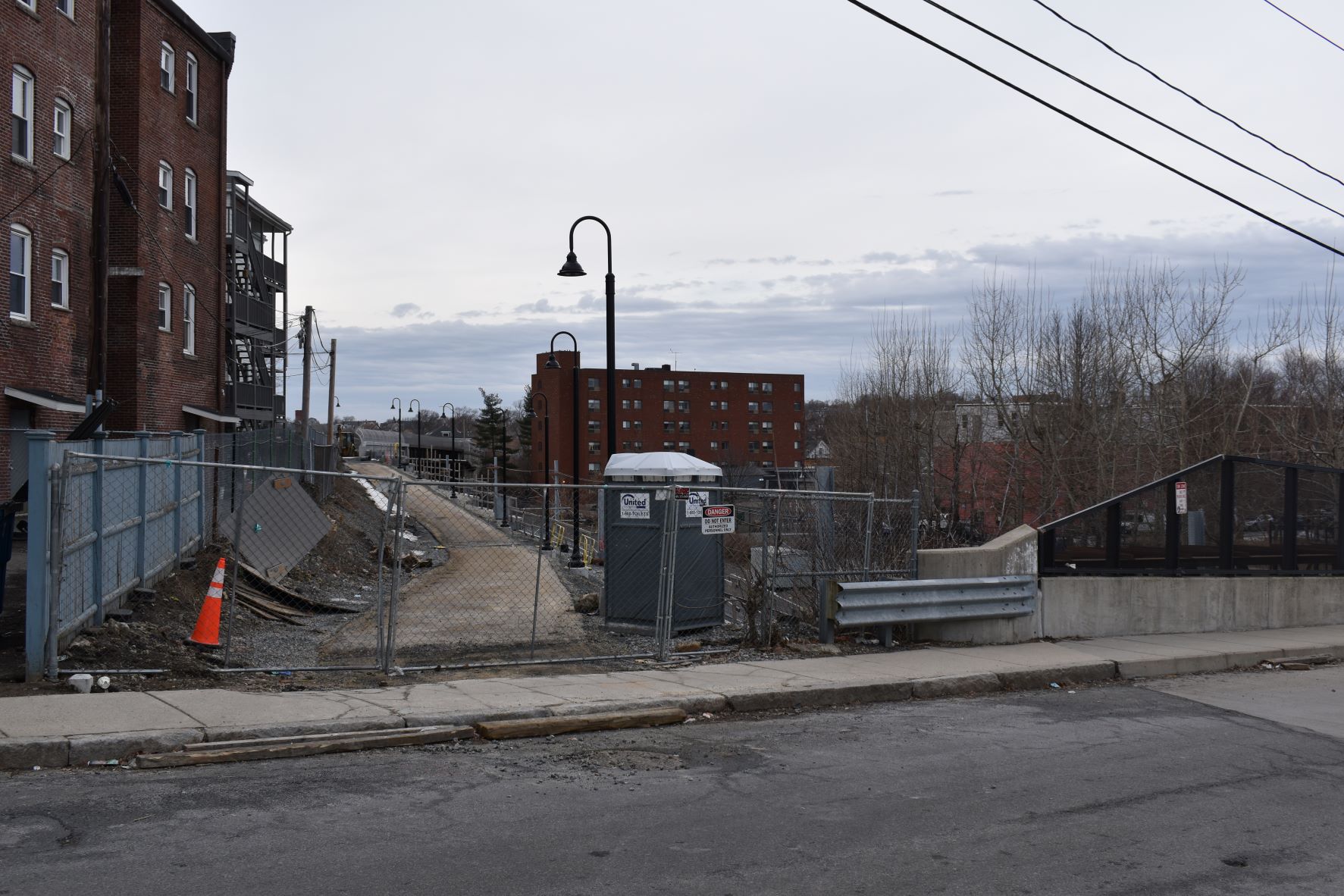 Trail lighting has been installed on many segments of the new Community Path. This is a view of the path construction looking west from Walnut Street, near Somerville's main library.
