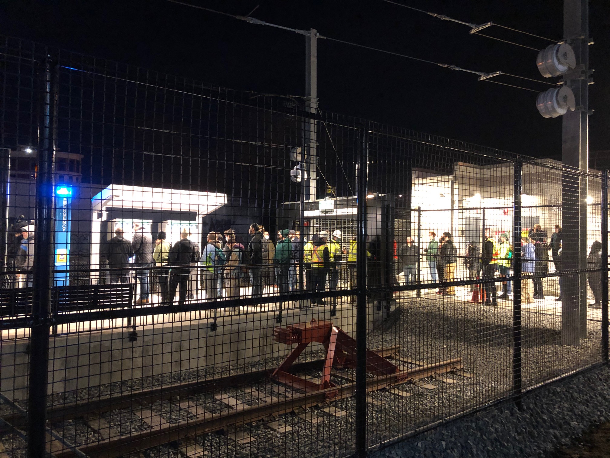 Passengers wait in line to validate their fares at the new Union Square Green Line station in Somerville.