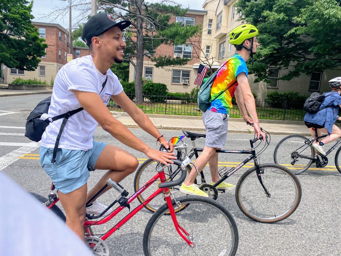 person wearing a white tshirt riding on a red bicycle