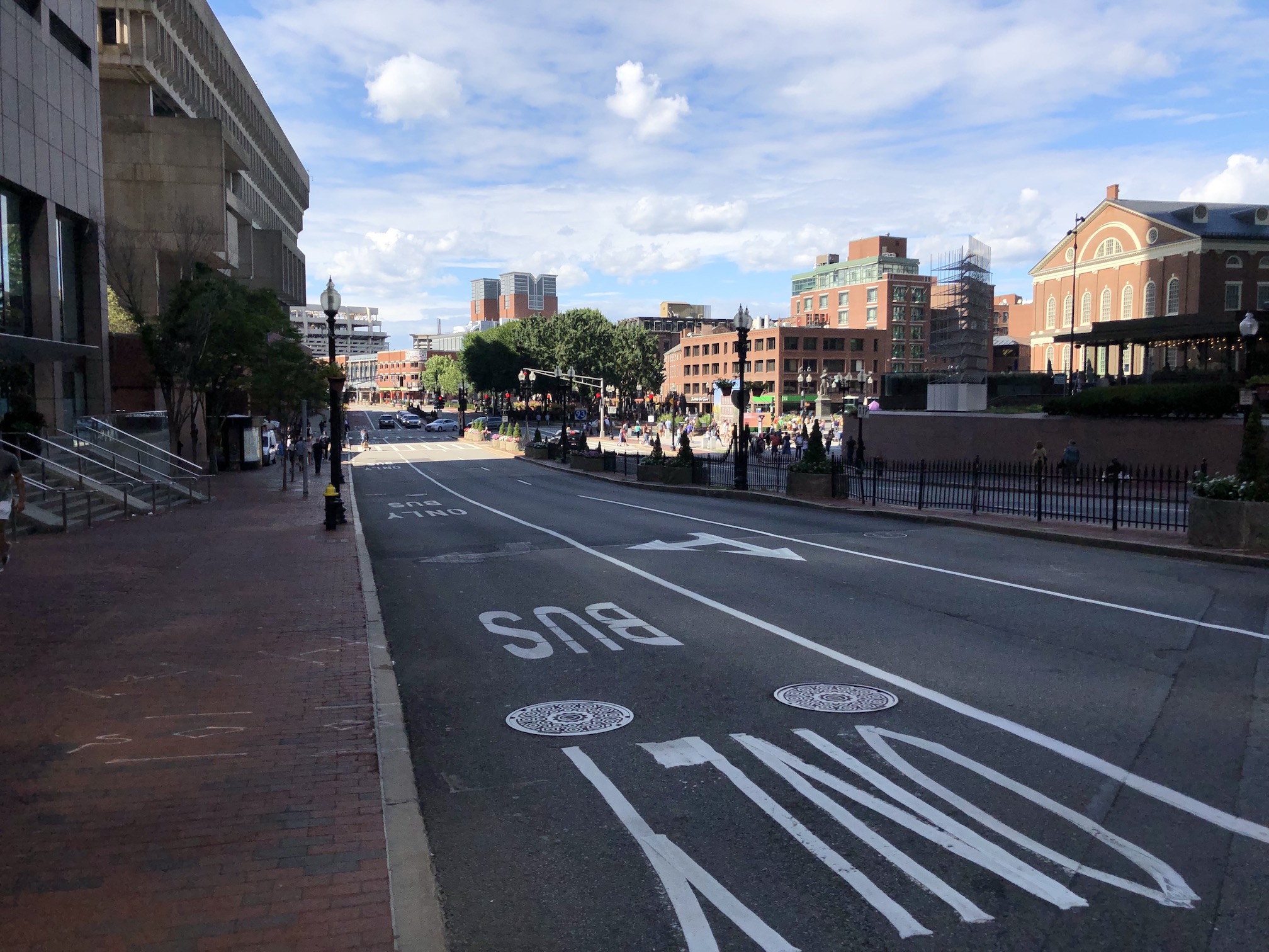 A lane marked "BUS ONLY" runs along the curb of Congress Street next to City Hall (left) and Faneuil Hall (right)