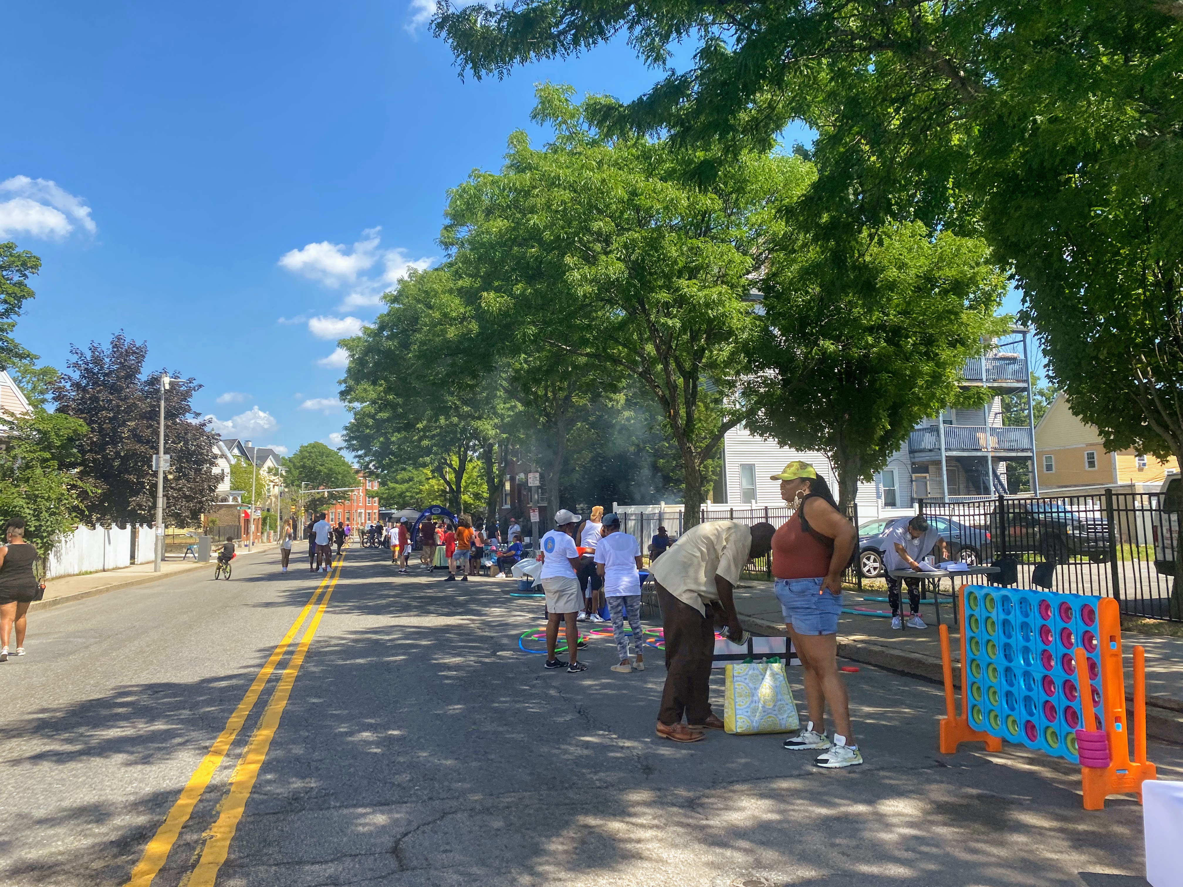 People walked and played on a stretch of Blue Hill Avenue closed off to car traffic this past Saturday in the Roxbury neighborhood as part of the City of Boston’s Open Streets series initiative. StreetsblogMASS was at the event during the morning portion when the heat index showed 94 degrees just before 11 a.m. Marcia, a Roxbury resident who was at the event accompanying her grandkids said, “the heat is too much, but you gotta stay hydrated. Do what you need to do.”