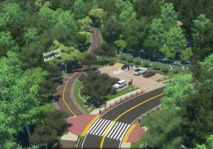 a paved path meandering through trees next to a parking lot by a road featuring a new sidewalk