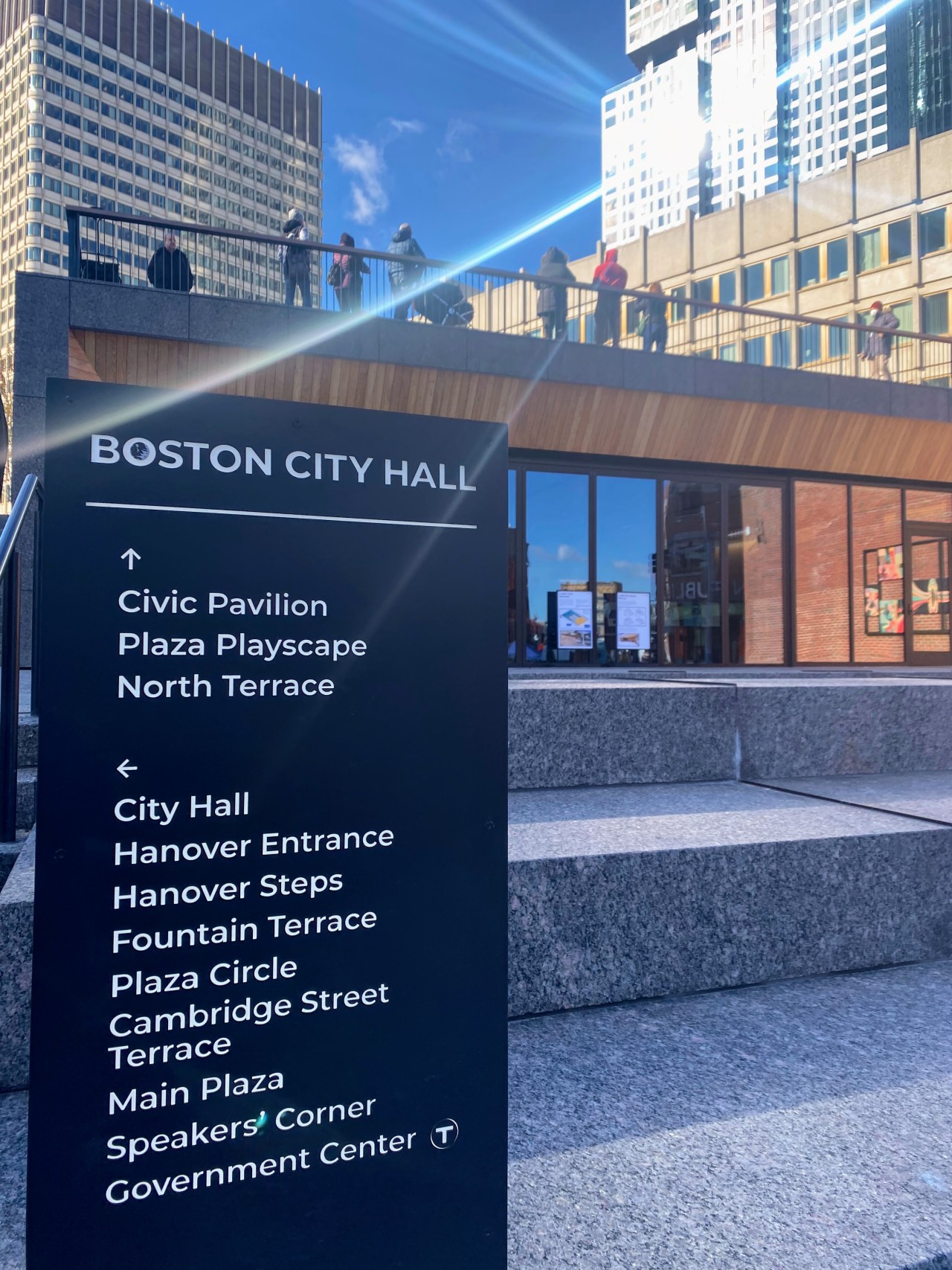 a group of eight people are seen on the rooftop terrace of the new civic pavilion