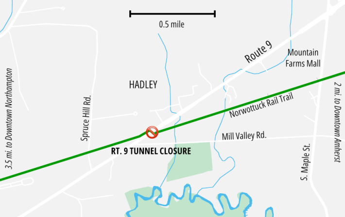 Map of Route 9 and the Norwottuck Rail Trail in Hadley. Route 9 runs diagonally from lower left (SW) to upper right (NE) while the green line representing the trail runs in a less-steep diagonal path that crosses Route 9 in the center. A red X at the intersection marks the location labelled "Rt. 9 Tunnel Closure". 