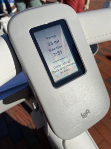 An LCD screen in a gray plastic housing displays battery life and a timer that displays the ride time. Text at the bottom of the screen reads "Done riding? Dock at a station to end."
