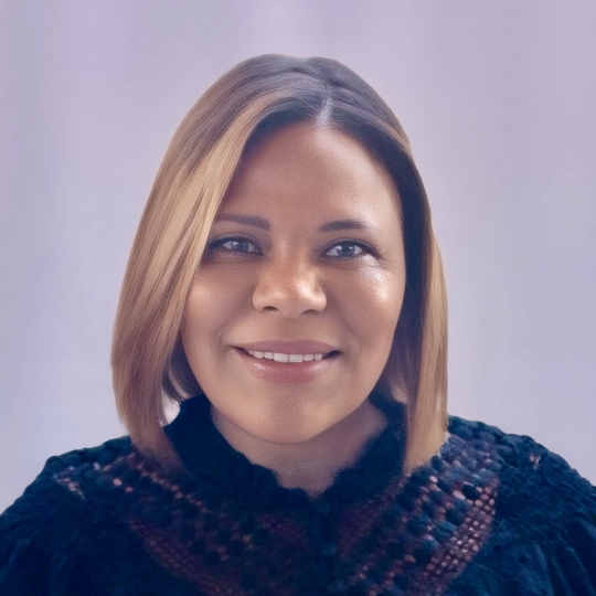 A portrait of a Black woman with straight shoulder-length hair