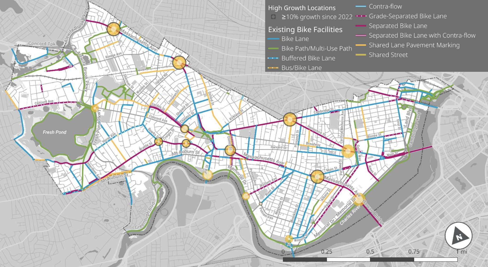 A map of Cambridge showing bike infrastructure (colored lines) and yellow dots that indicate bike traffic count volumes. The biggest yellow dots are located along Mass. Ave. and Hampshire Street where there are protected bike lanes. 