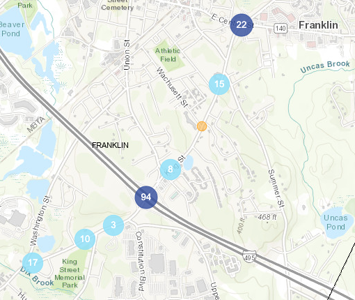 A map of King Street in Franklin, with Interstate 495 crossing diagonally from upper left to lower right and King Street crossing from lower left to upper right, showing circles that indicate the density of crashes along King Street. A dark blue circle labelled "94" indicates 94 crashes near the I-495 interchange. Another dark blue circle labelled "22" indicates 22 crashes at the intersection of King and Central Streets in central Franklin. Smaller dots with numbers under 20 line the remainder of the street. 