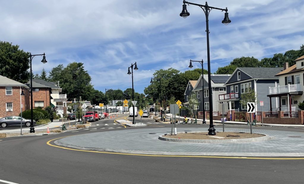A roundabout surrounded by 2- and 3-story buildings in a mostly residential neighborhood