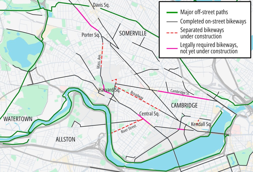 A map of Cambridge and Somerville highlighting bike lane projects completed and under construction. Red dashed lines on Broadway (center) and River Street highlight projects under construction now.